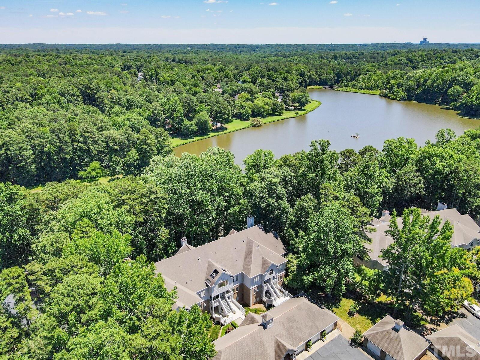 7500 Cadbury Court, Unit 101 Raleigh, NC 27615 - Photo 32 of 41 a aerial view of a house with a yard and lake view