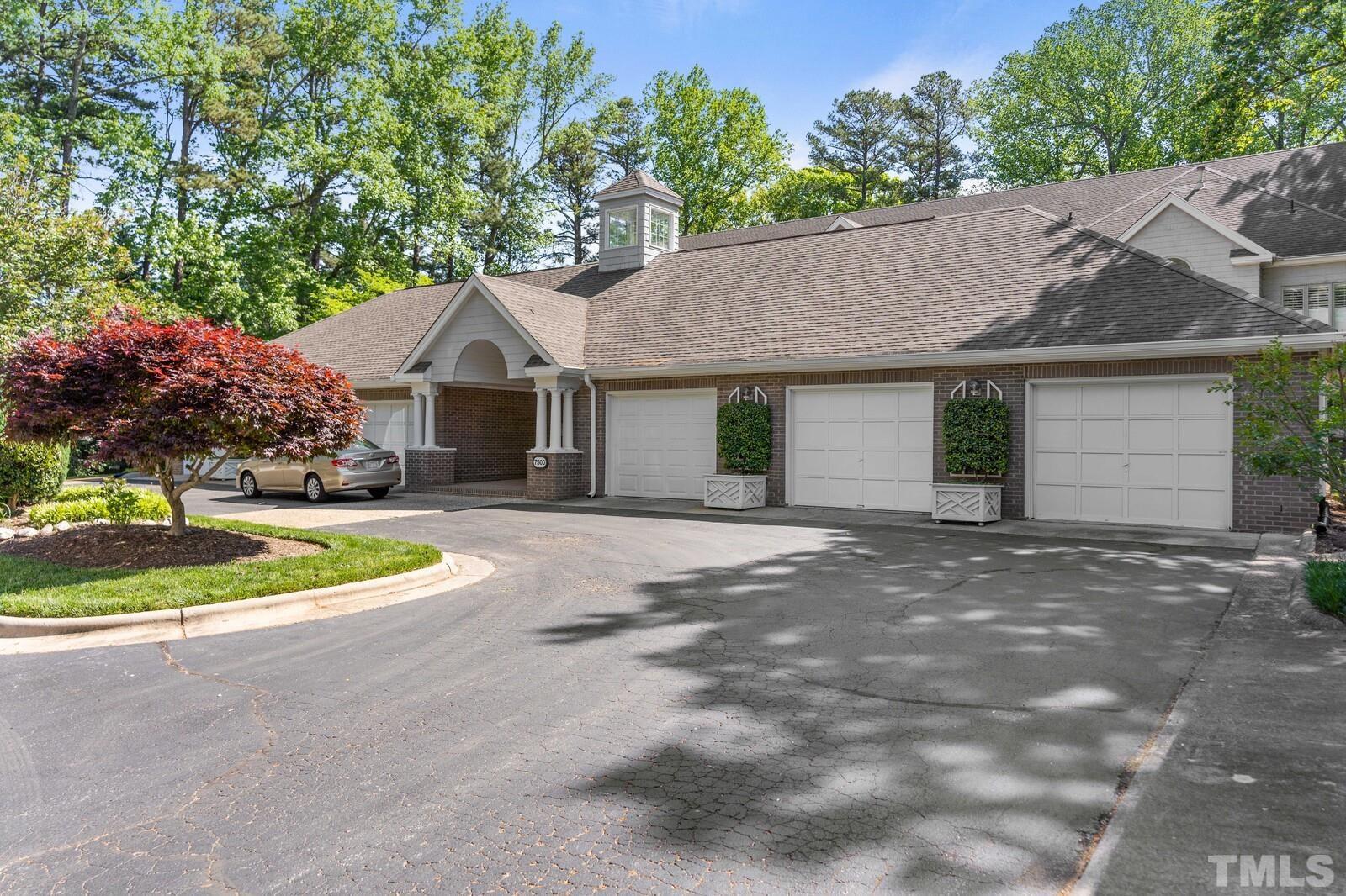 7500 Cadbury Court, Unit 101 Raleigh, NC 27615 - Photo 40 of 41 a front view of a house with a yard and garage