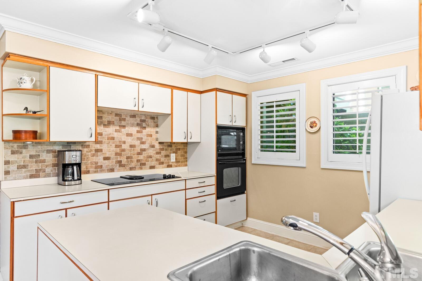 7500 Cadbury Court, Unit 101 Raleigh, NC 27615 - Photo 7 of 41 a kitchen with a refrigerator a stove and a sink