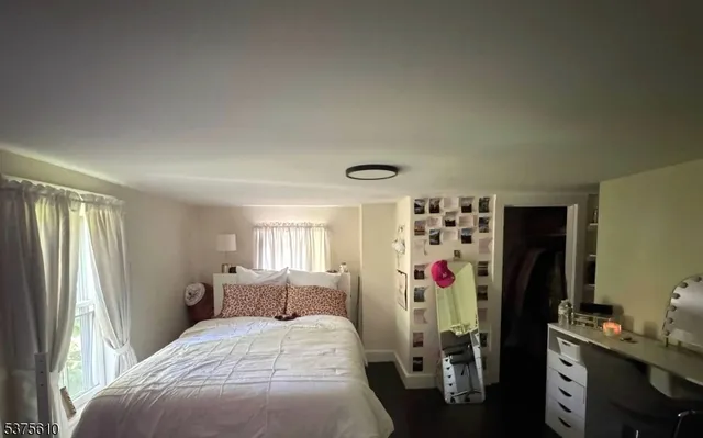 a bedroom with bed and a window