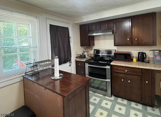 a kitchen with a sink stove and cabinets