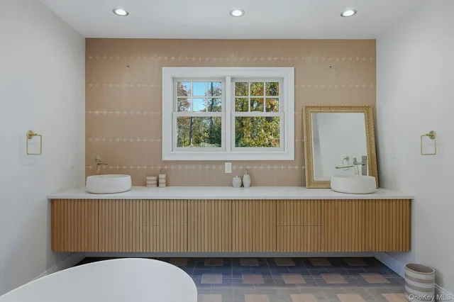 a bathroom with a granite countertop sink a mirror and a toilet