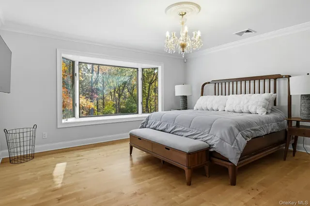 a bedroom with a bed and a chandelier