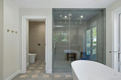 a spacious bathroom with a toilet a sink and shower