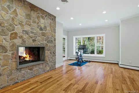 a living room with a fireplace and a fireplace