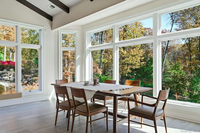 a view of a dining room with furniture window and wooden floor