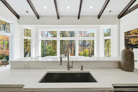 a kitchen with a sink and a large window