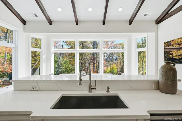 a kitchen with a sink and a large window