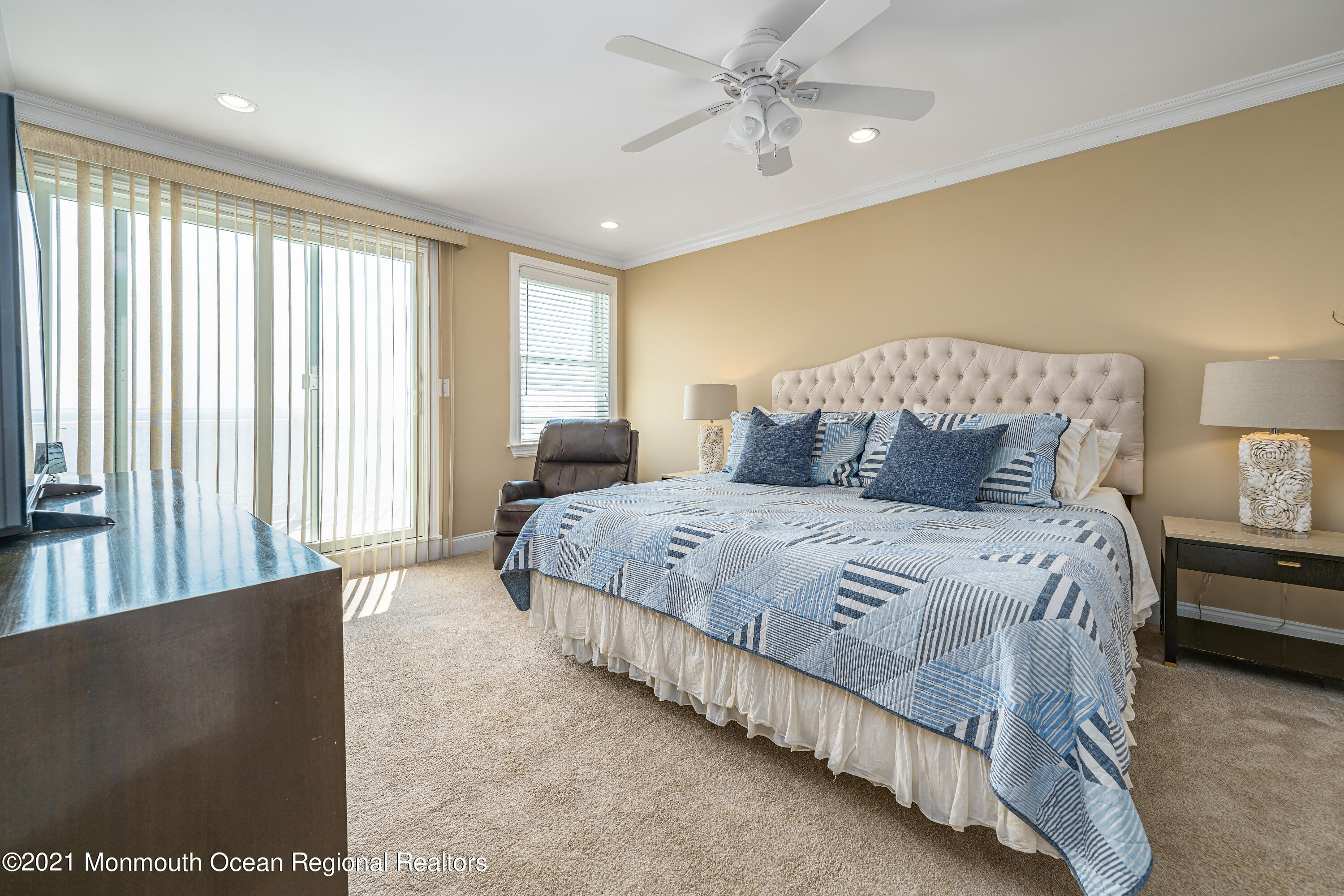 117 Clifton Road Barnegat, NJ 08005 - Photo 29 of 44 a bedroom with a large bed and a chandelier