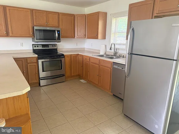 a kitchen with a refrigerator sink and microwave