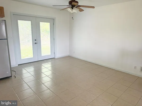 an empty room with windows and closet
