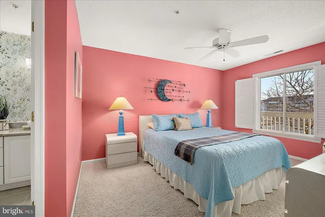 a bathroom with a toilet sink vanity and mirror
