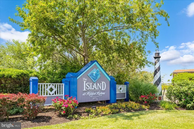 a view of a patio with a table and chairs under an umbrella