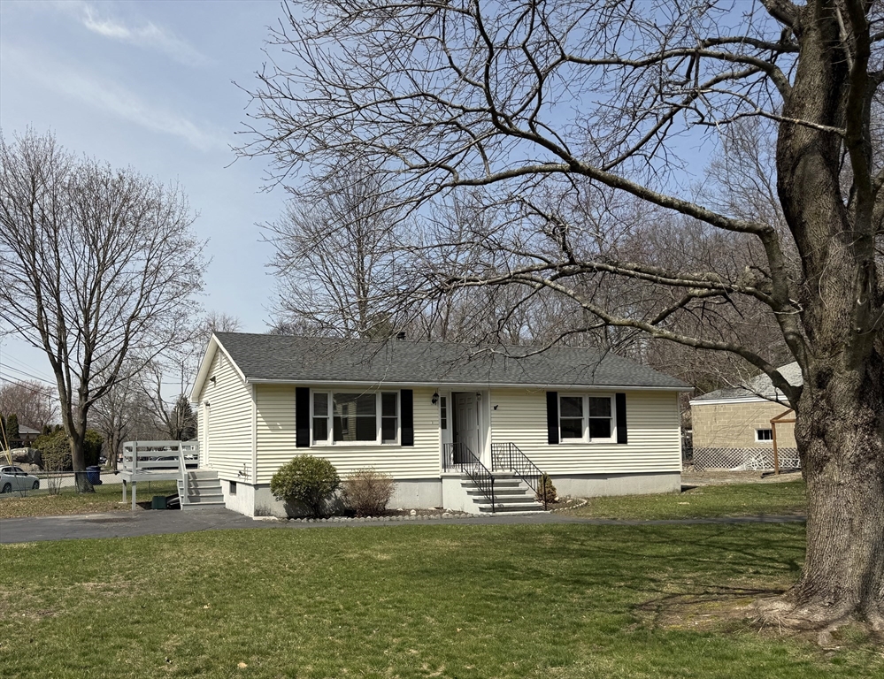 a front view of a house with a garden