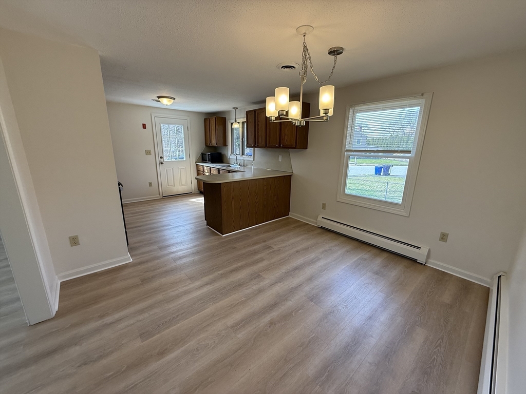 1 Joyce Road Peabody, MA 01960 - Photo 3 of 12 an empty room with wooden floor and windows