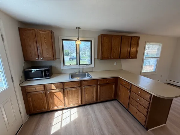 a kitchen with stainless steel appliances granite countertop wooden cabinets a sink and a stove