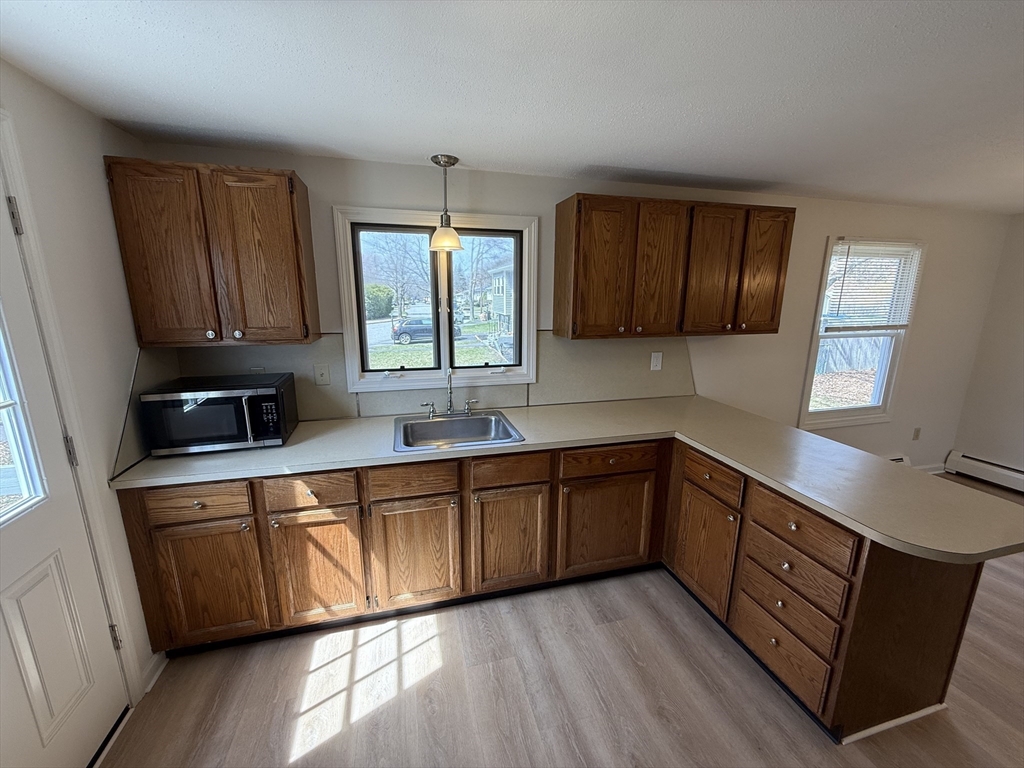 1 Joyce Road Peabody, MA 01960 - Photo 4 of 12 a kitchen with stainless steel appliances granite countertop wooden cabinets a sink and a stove