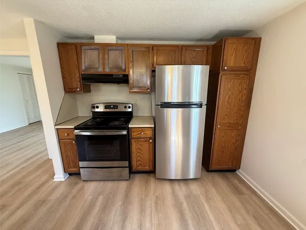 a kitchen with a refrigerator and a stove