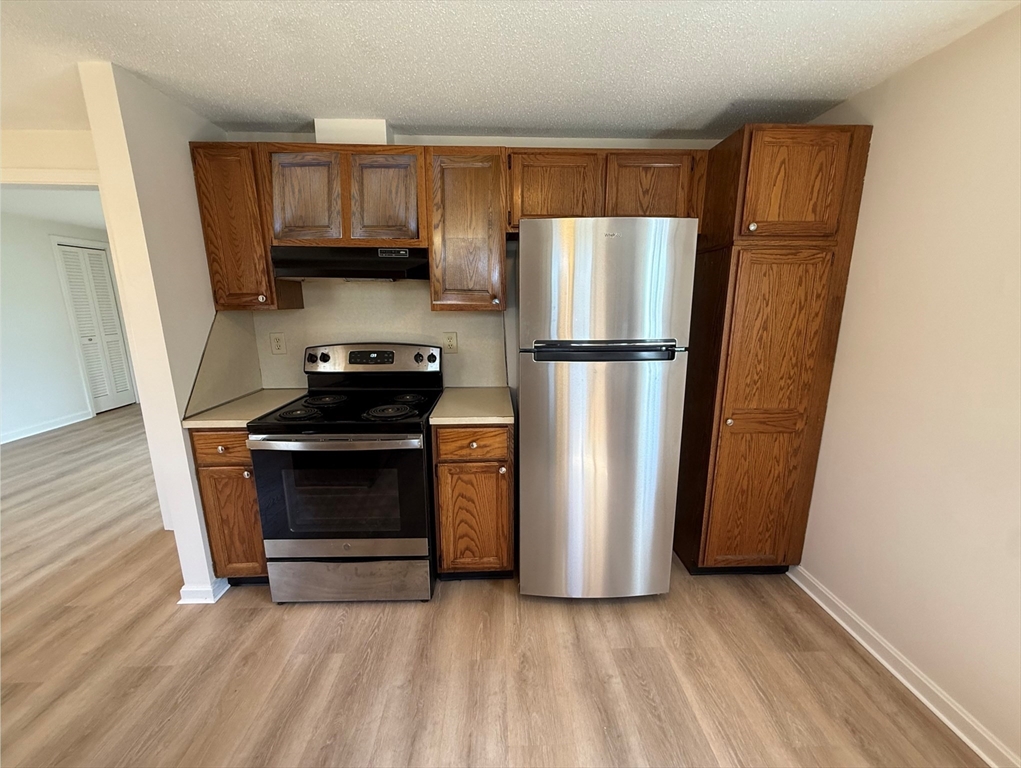1 Joyce Road Peabody, MA 01960 - Photo 5 of 12 a kitchen with a refrigerator and a stove