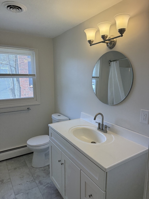 1 Joyce Road Peabody, MA 01960 - Photo 6 of 12 a bathroom with a toilet a sink and mirror