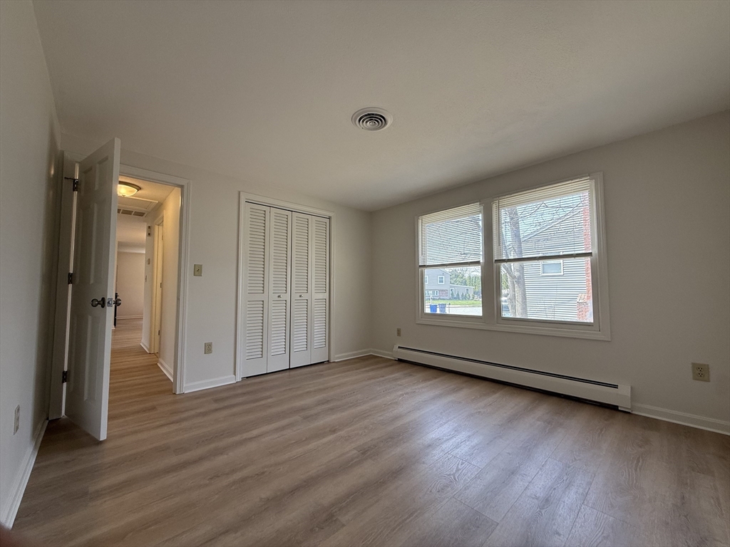 1 Joyce Road Peabody, MA 01960 - Photo 9 of 12 an empty room with wooden floor and windows