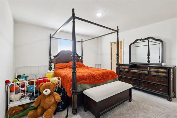 a bedroom with bed and wooden floor
