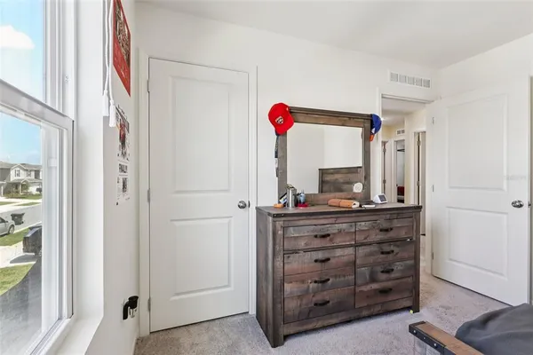 a room with a dresser and a mirror