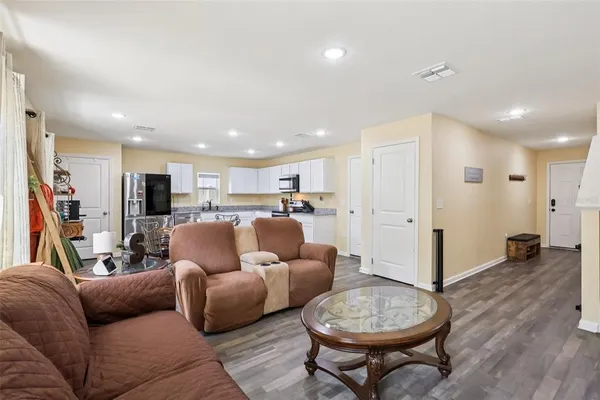 a living room with furniture a ceiling fan and a rug