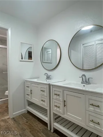 a bathroom with 2 sink and a mirror