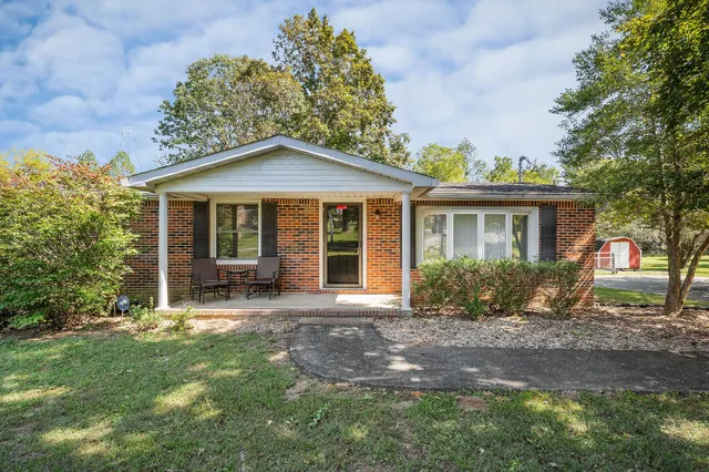 a front view of a house with a yard and porch