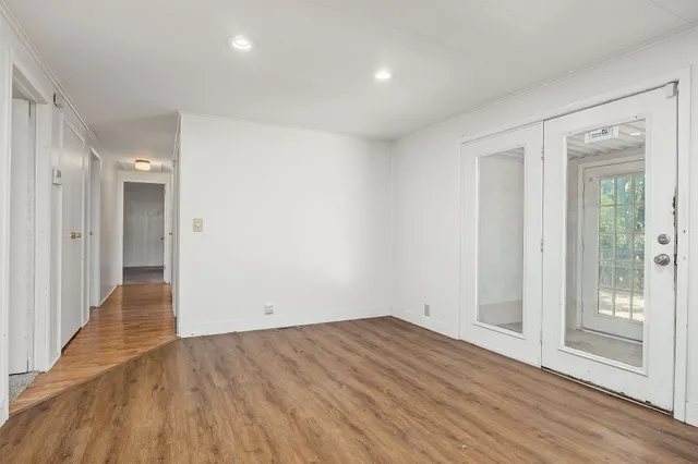wooden floor in an empty room with a window