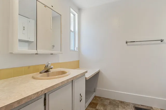 a bathroom with a sink and vanity