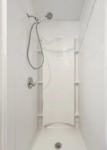 a bathroom with a glass shower door