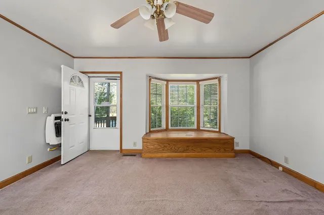 a spacious bedroom with a bed and a chandelier