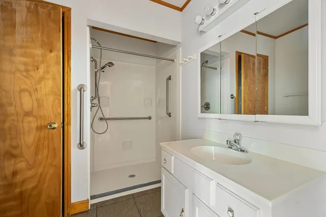 an empty room with windows and fan view