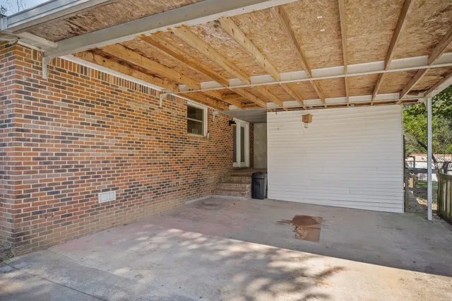 a view of a house with backyard porch and sitting area