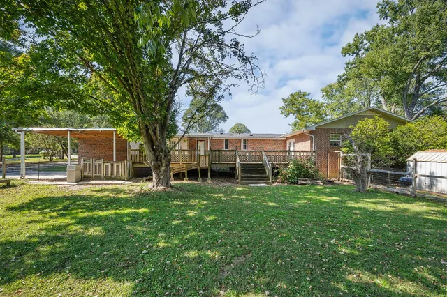 a view of a house with a backyard