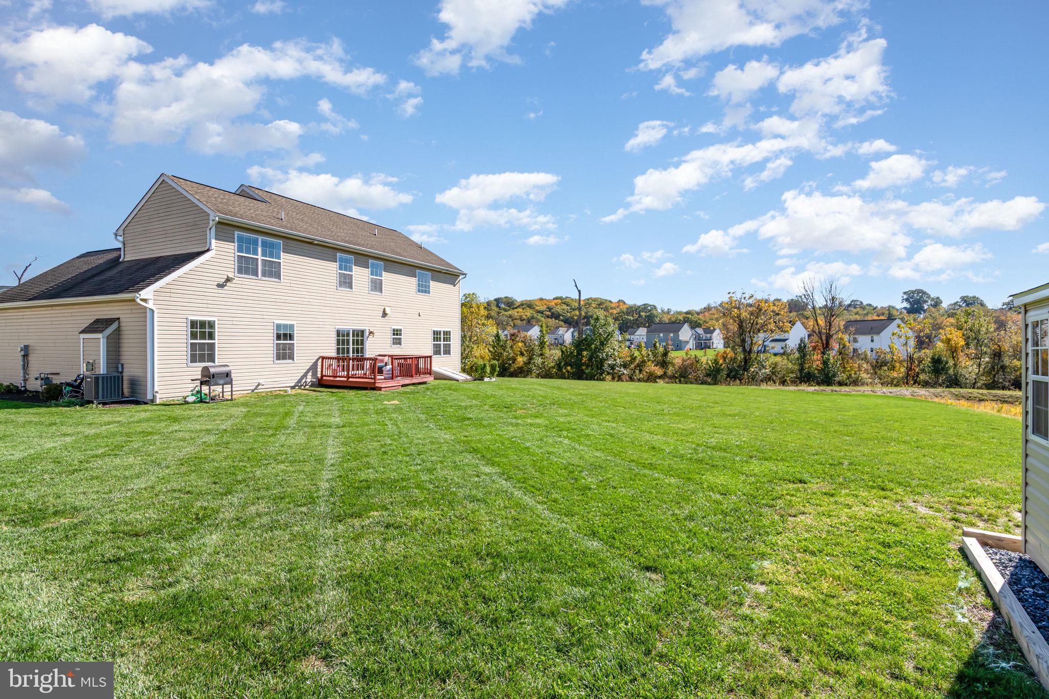 2786 Silver Maple Drive Harrisburg, PA 17112 - Photo 19 of 25 a view of a white house in front of a big yard with plants and large trees