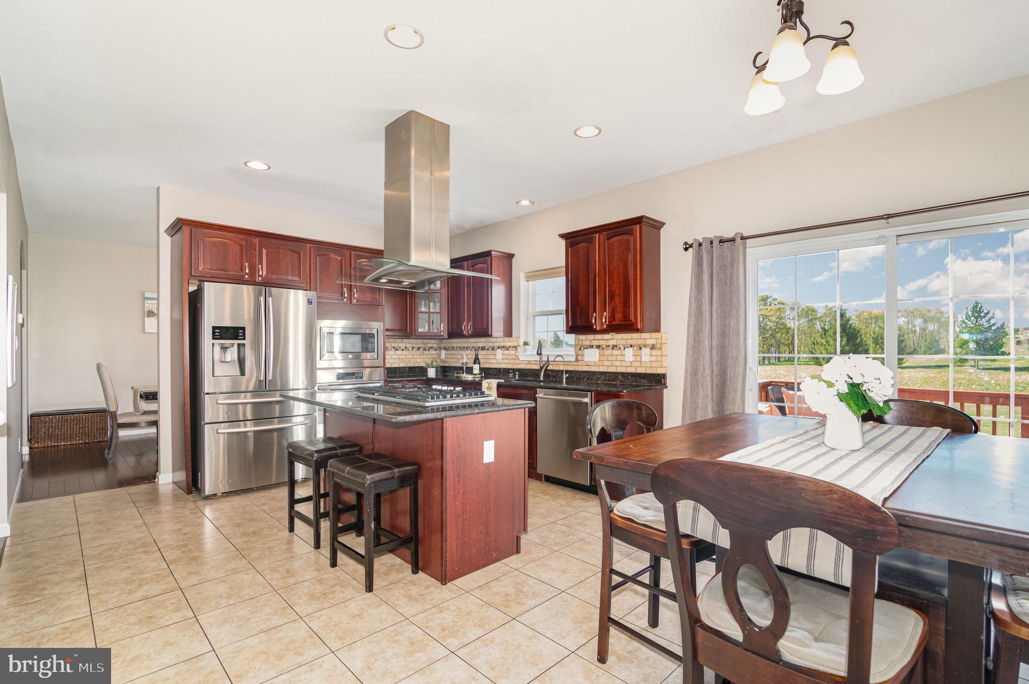 2786 Silver Maple Drive Harrisburg, PA 17112 - Photo 5 of 25 a kitchen with a dining table chairs and refrigerator