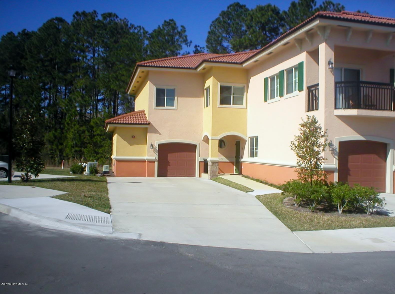 9745 Touchton Road, Unit 2401 Jacksonville, FL 32246 - Photo 1 of 50 a front view of a house with a yard and garage