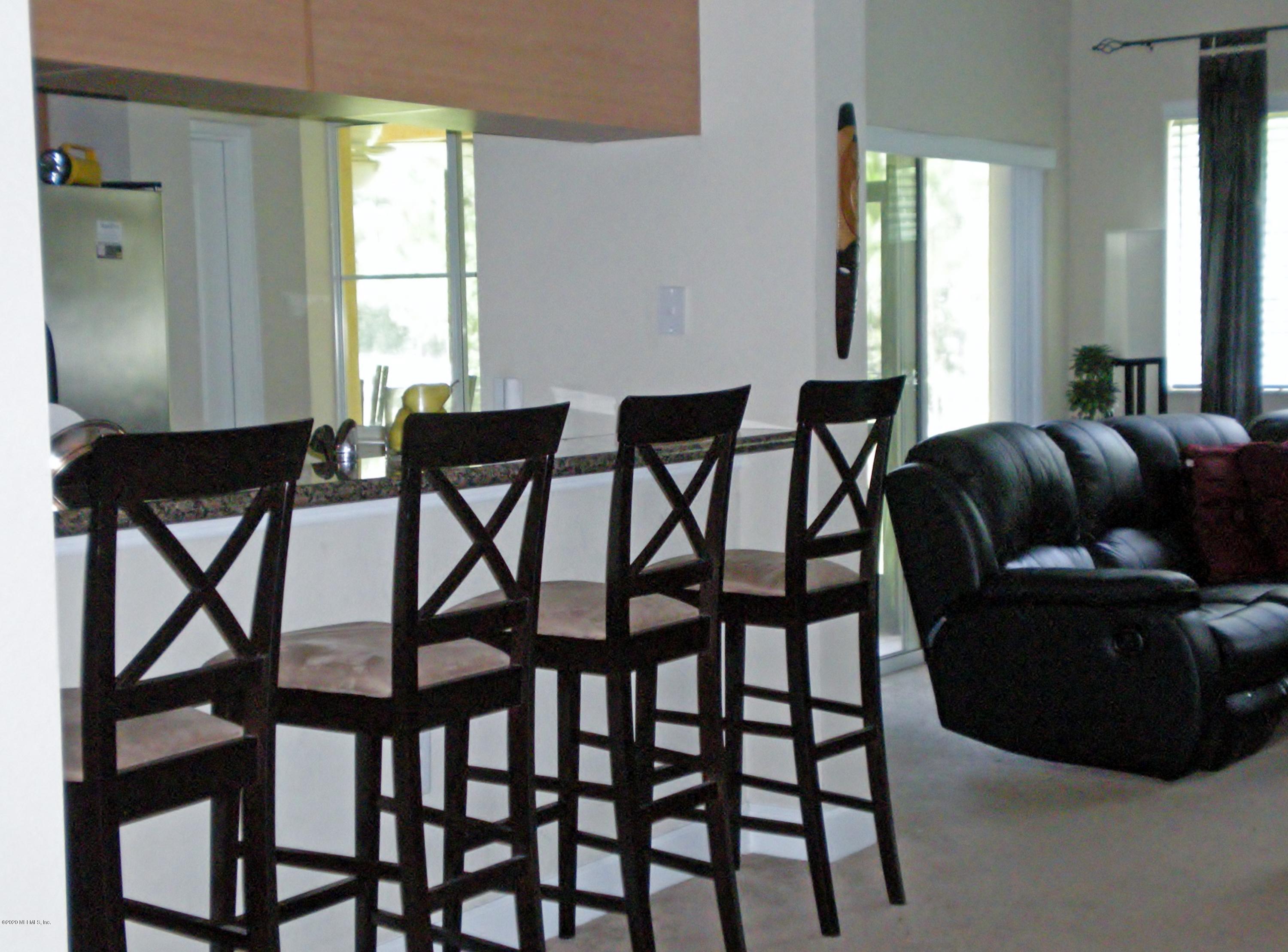 9745 Touchton Road, Unit 2401 Jacksonville, FL 32246 - Photo 12 of 50 a living room with furniture and a window
