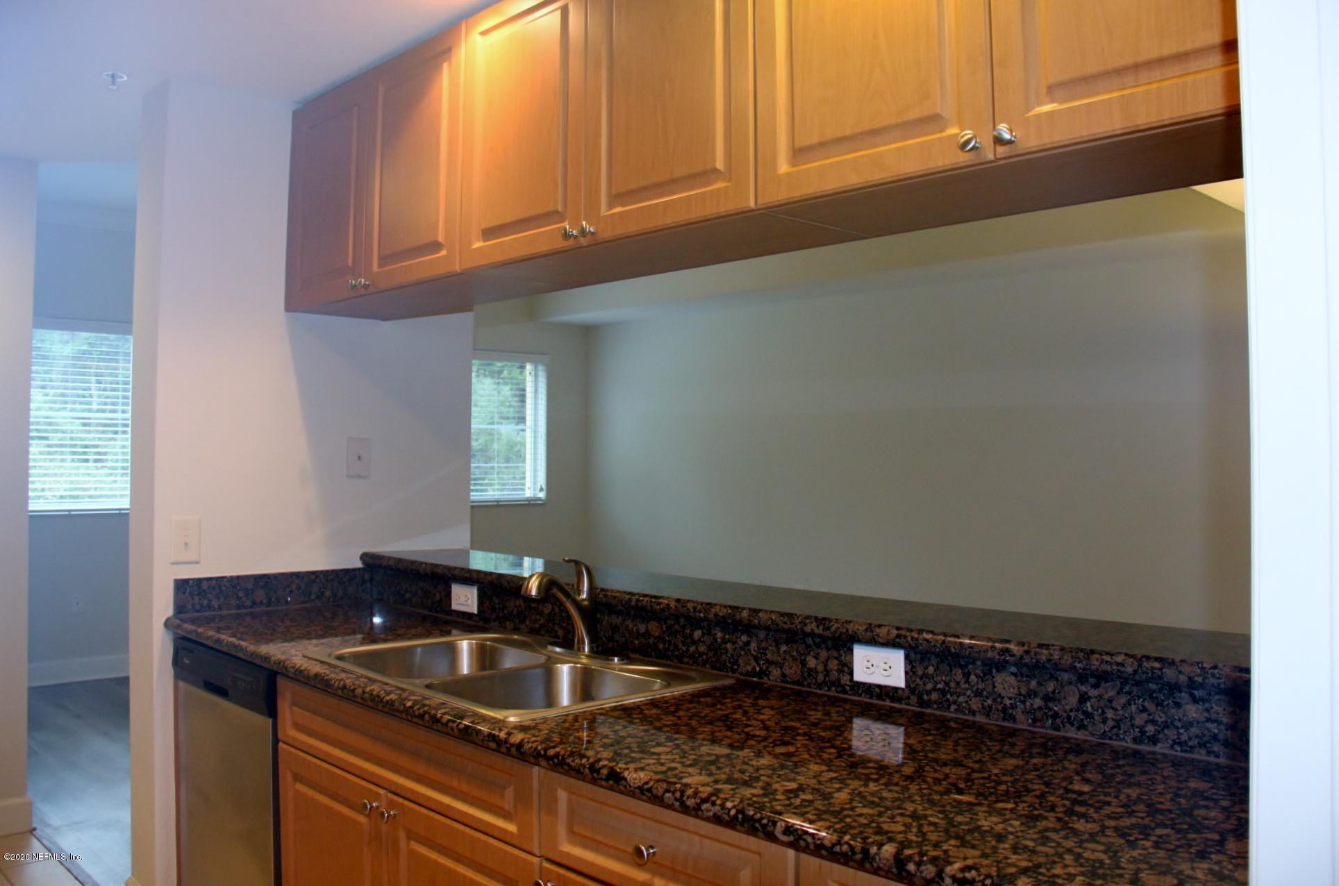 9745 Touchton Road, Unit 2401 Jacksonville, FL 32246 - Photo 18 of 50 a kitchen with granite countertop a sink and a stove
