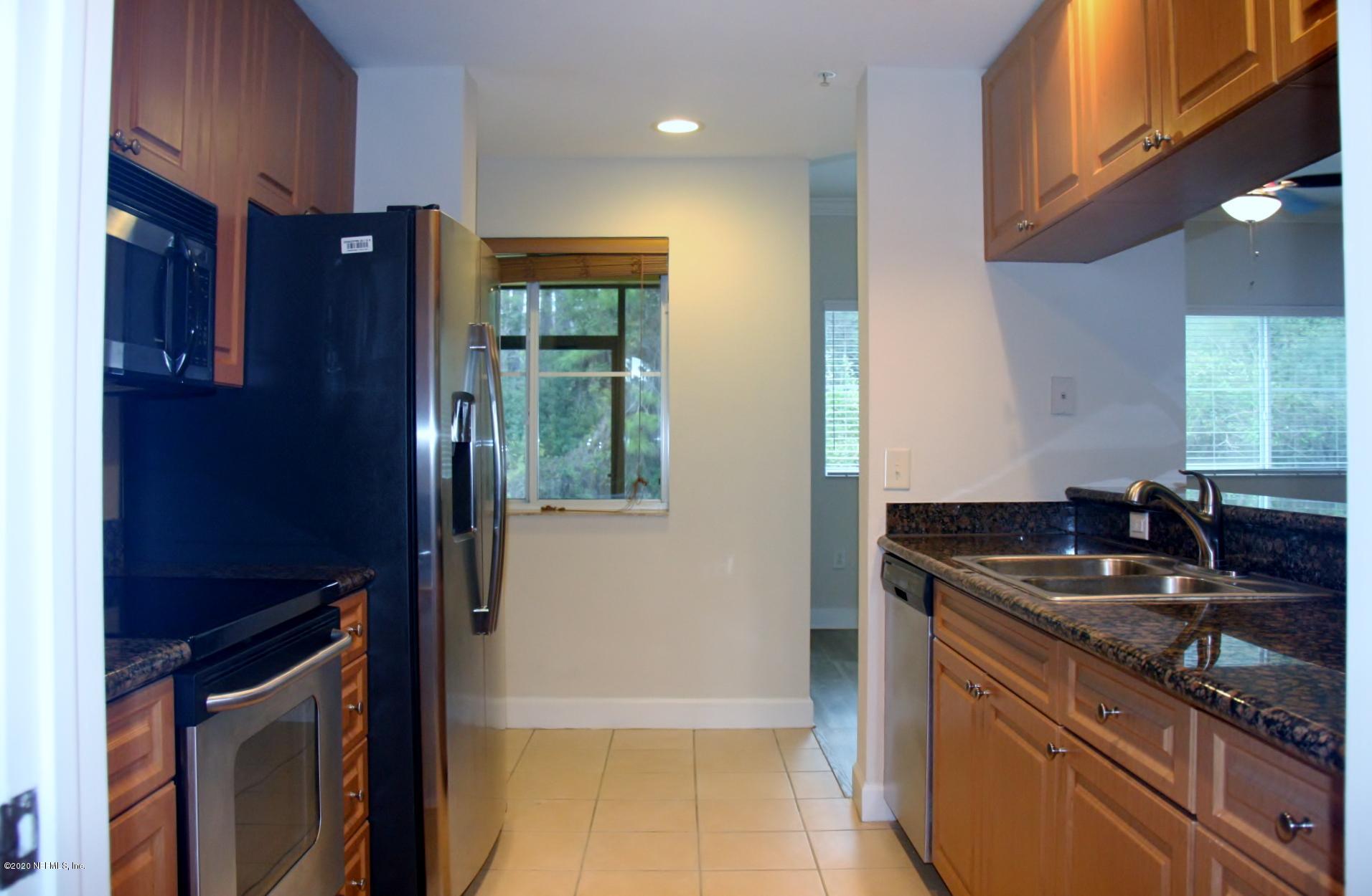 9745 Touchton Road, Unit 2401 Jacksonville, FL 32246 - Photo 21 of 50 a kitchen with stainless steel appliances granite countertop a sink stove and refrigerator