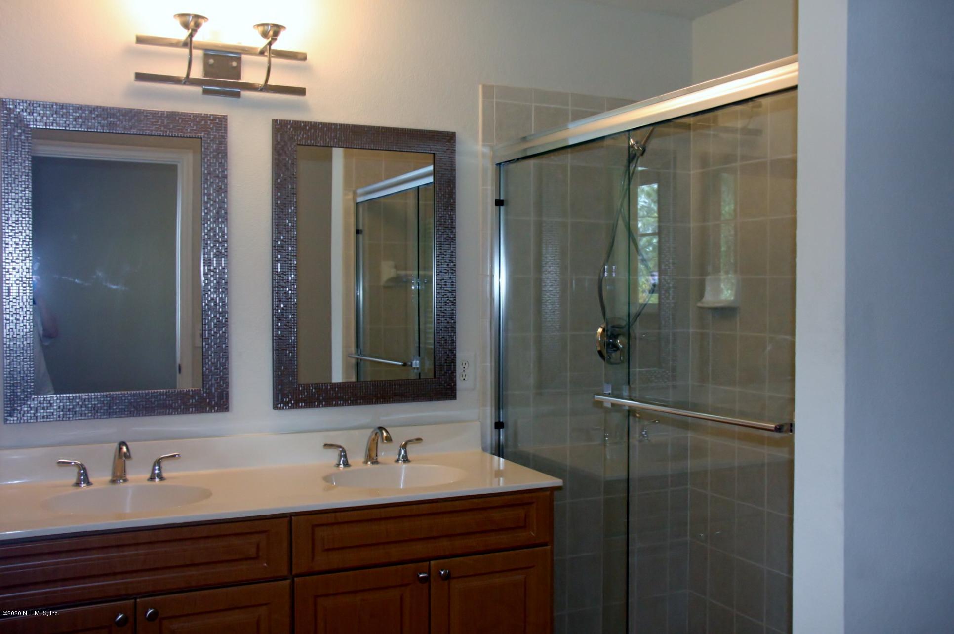 9745 Touchton Road, Unit 2401 Jacksonville, FL 32246 - Photo 28 of 50 a bathroom with a sink and mirror