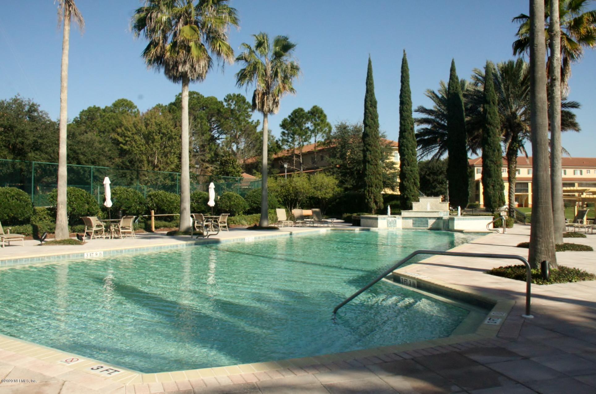 9745 Touchton Road, Unit 2401 Jacksonville, FL 32246 - Photo 40 of 50 a view of a swimming pool with a table and chairs