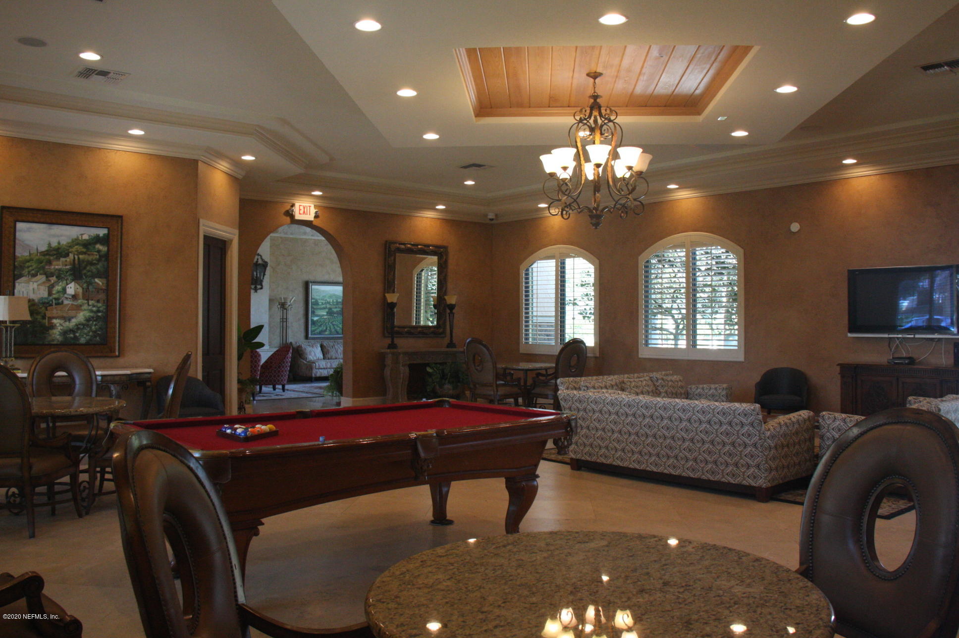 9745 Touchton Road, Unit 2401 Jacksonville, FL 32246 - Photo 45 of 50 a living room with furniture a large window and a chandelier
