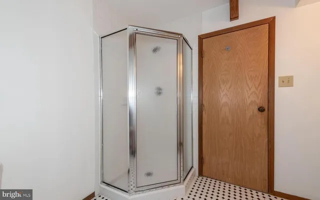 a bathroom with a glass shower door