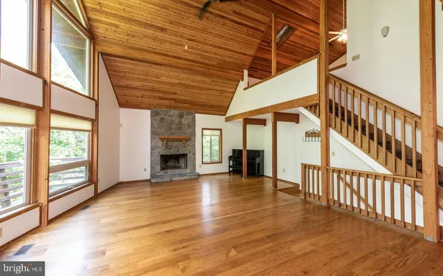 a view of an entryway with wooden floor stairs and a yard