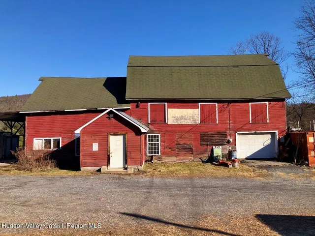 a view of a house with a yard and roof