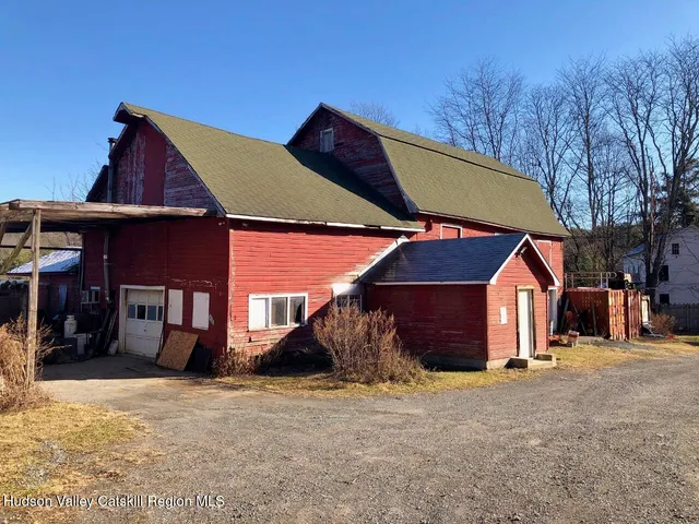 a view of a house with a yard and sitting area